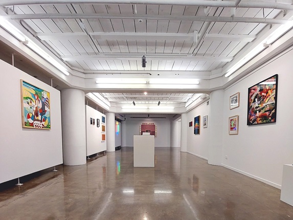 A gallery with art on the walls.