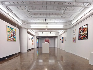 A gallery with art on the walls.