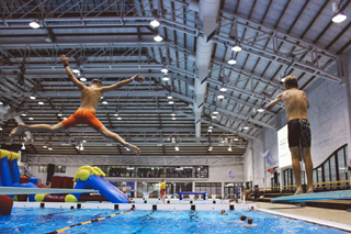 People jumping into the pool.