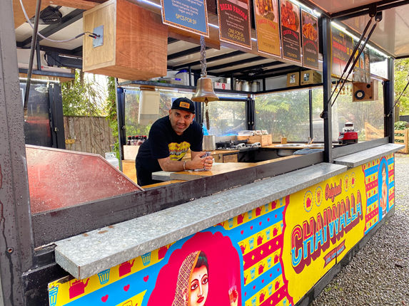 Man smiling from a food truck.