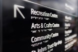 Detail of navigational signpost in English and Braille.