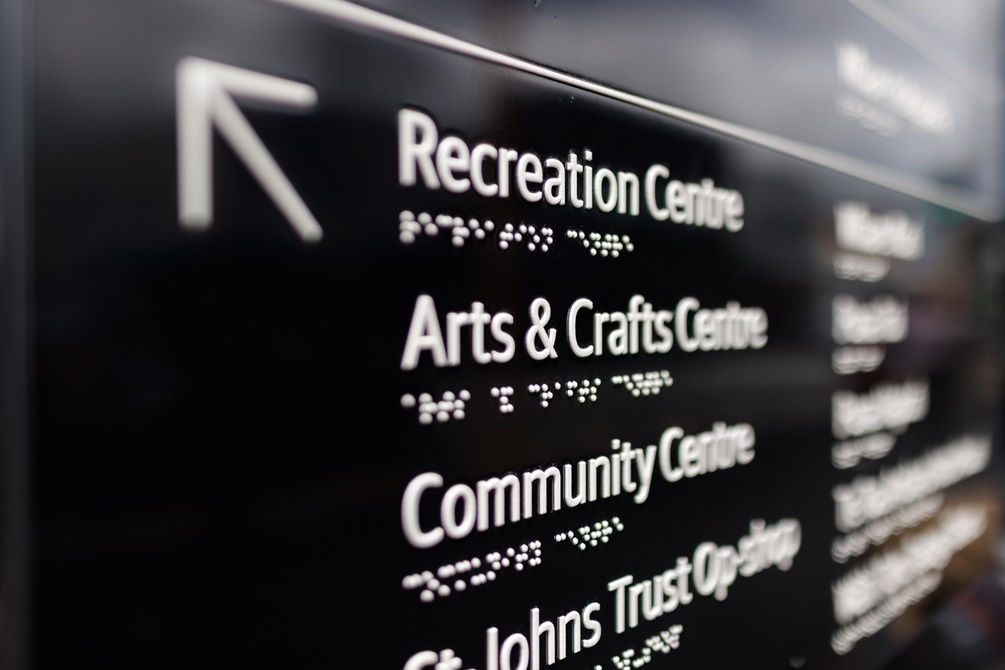 Detail of navigational signpost in English and Braille.