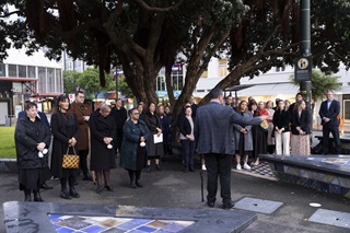 Group of people standing out the front of Te Aro Park toilets.