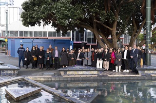 A group including council staff and Mana Whenua posing for a photo in Te Aro Park toilets.