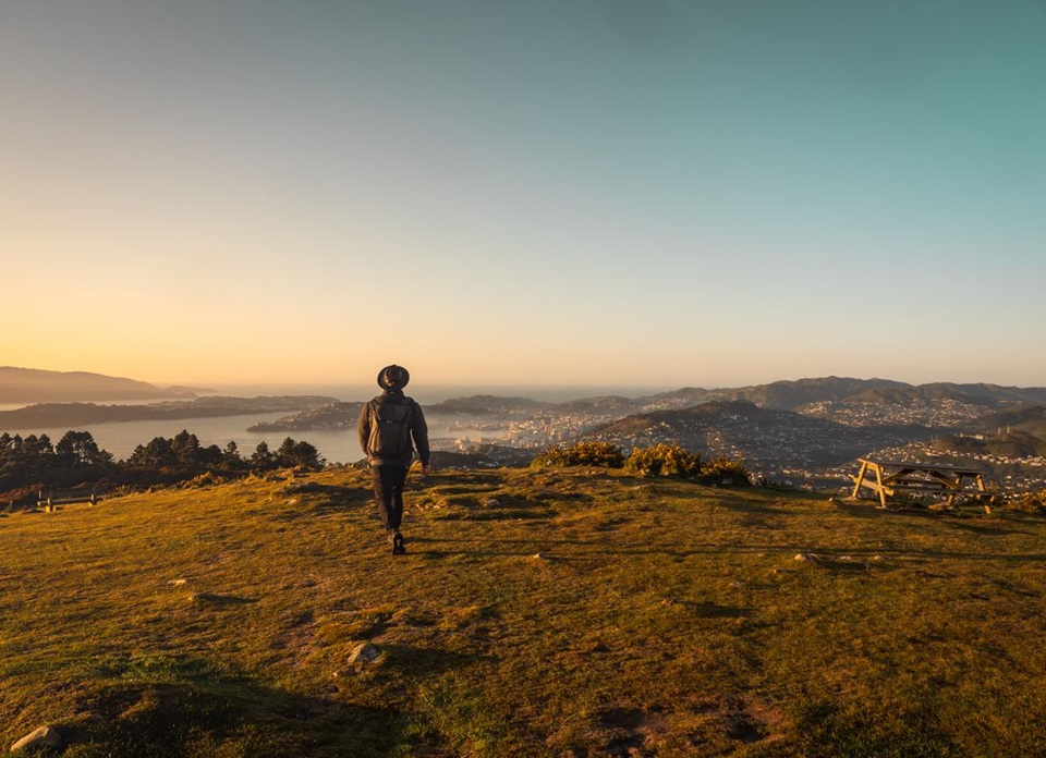 Man walking on Skyline track with views of the city.