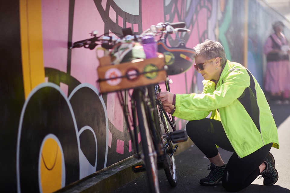 Person securing items on bicycle.