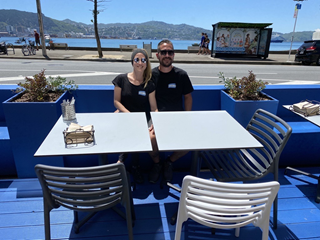 Two people sitting at their parklet.