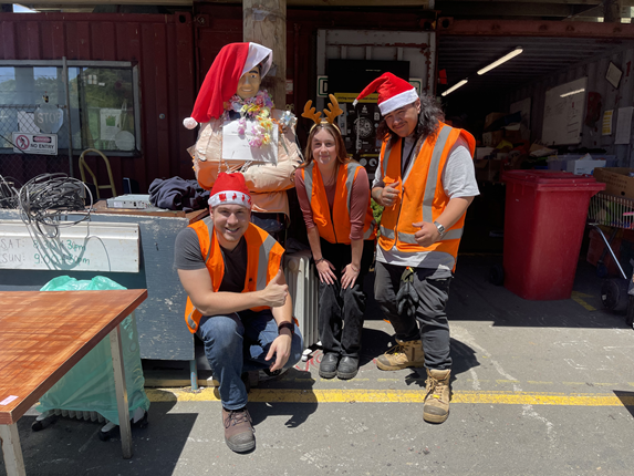 Group of people at wearing high vis and santa hats.