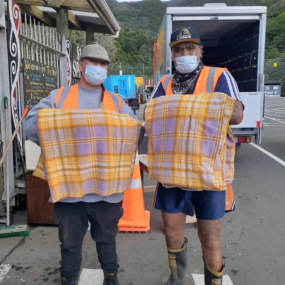Tip Shop team with some vintage blankets recovered from the landfill.