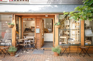 Alleyway with a cafe at the end of it.