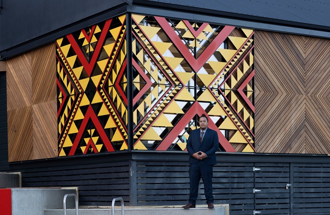Person standing infront artwork.
