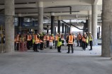 Te Matapihi interior view floor under construction with tour in progress