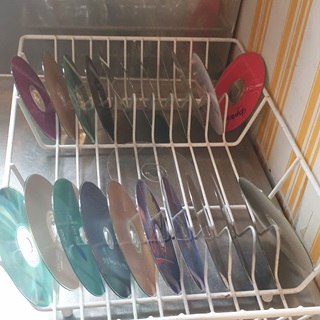 DVDs in a dish rack.