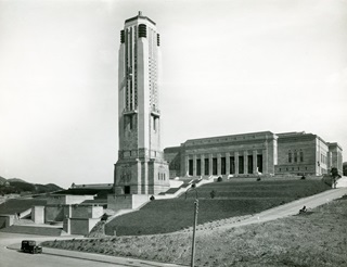 Black and white buildings with the war memorial in the front and the dominion building in the back.