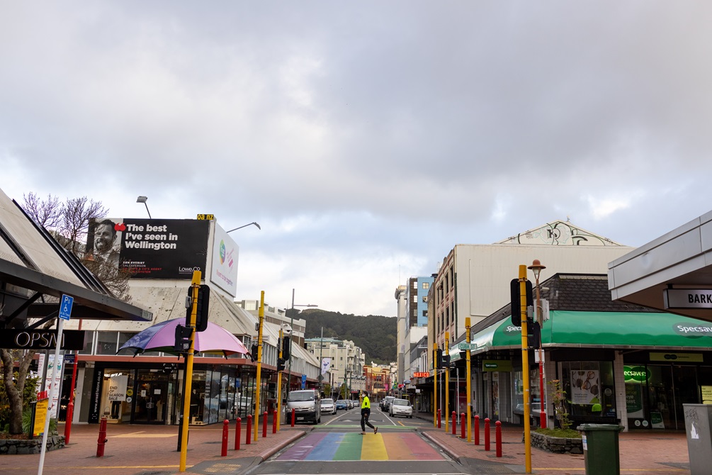 A long shot of the rainbow crossing in the middle of the COVID-19 lockdown with a singular person walking across it.