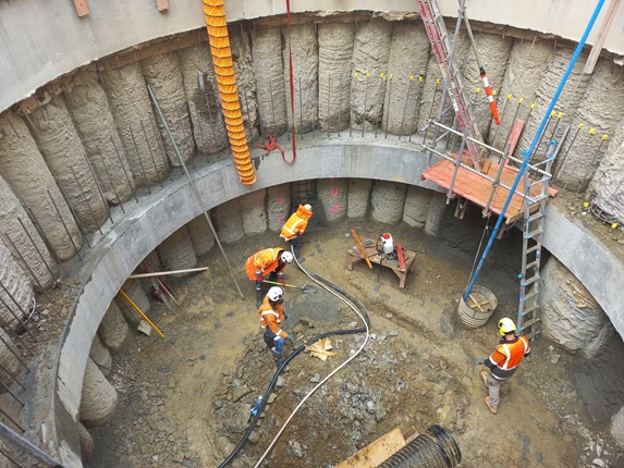 Four workers in high vis working on a pump station.