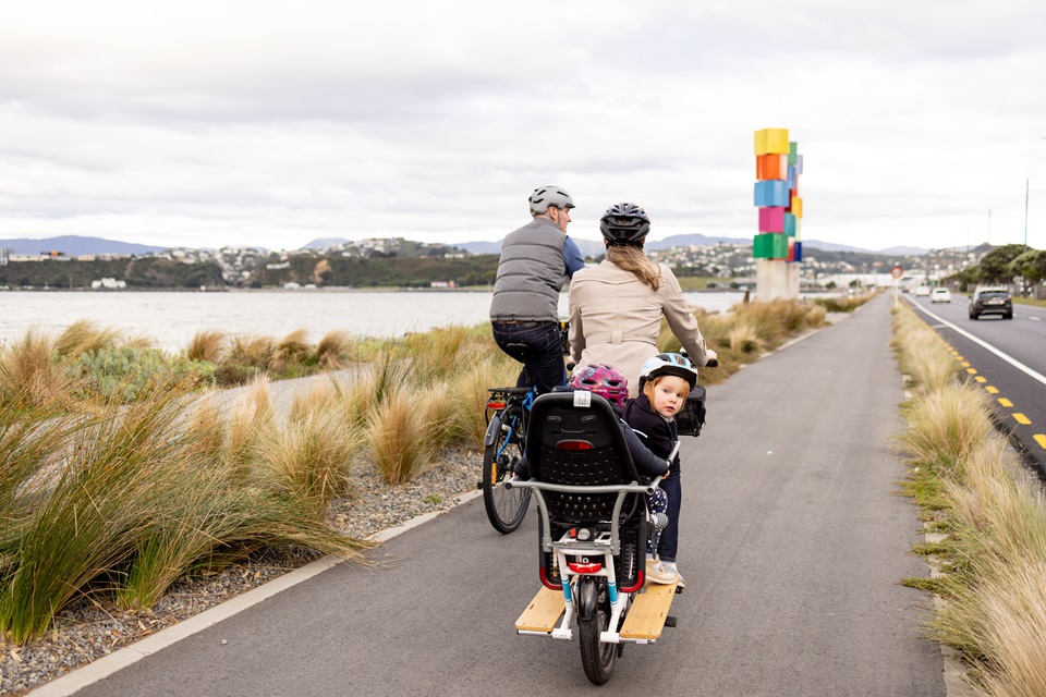 Family riding bikes along Cobham Drive shared pathways.