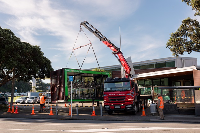 Bike shelter being installed outside of a swimming pool.
