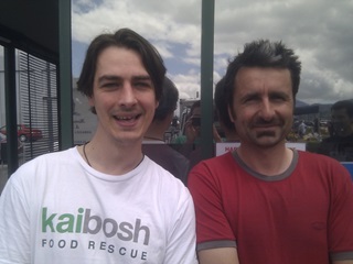 Two men smiling at the camera.