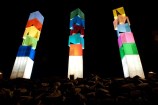 Lit up towers on top of rocks.