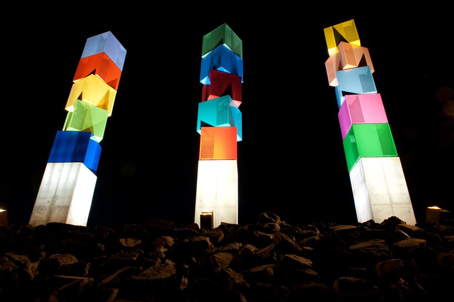 Lit up towers on top of rocks.