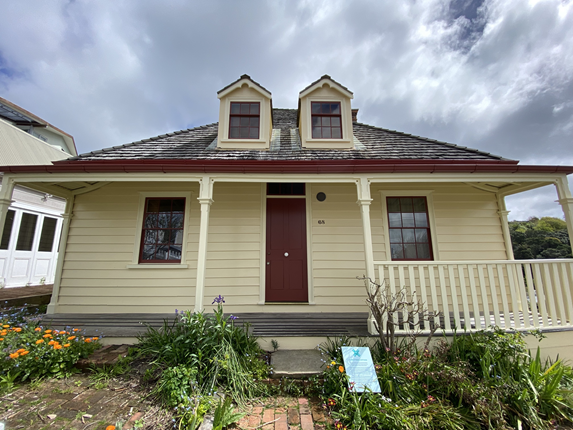 Front view of an early colonial cottage.