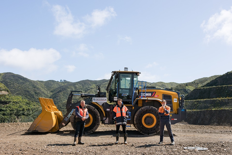 Darren Hoskins, Chris Matthews and Steven Hill in front of truck with landfill in background