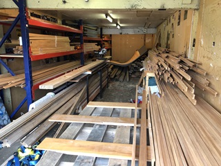 Piles of wood in a shed.