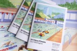 Three copies of the summer Our Wellington magazine on top of the original cover artwork, which is a painting of the outdoor Thorndon Pool.
