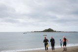 Group of people swimming in the ocean.