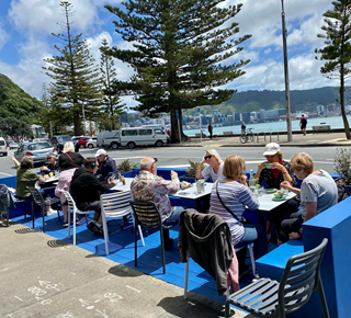 Group of people sitting in outdoor seating.