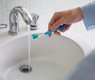 Person brushing their teeth.