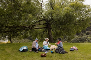 Group of people having a picnic in the park.