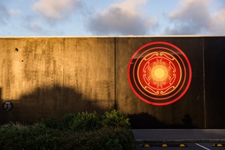 Giant gold auripo on a black wall.
