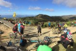 Group of bike riders in a circle on top of Makara Peak.