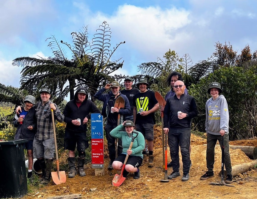 Group of cyclists on top of Makara Peak smiling for the camera.