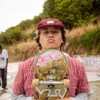 Person holding a skateboard.