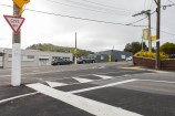 A new raised pedestrian crossing on a suburban street corner.
