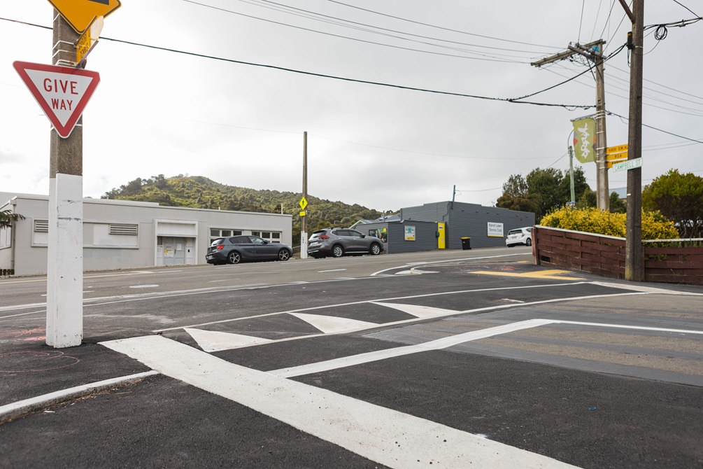 A new raised pedestrian crossing on a suburban street corner.