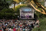 Gardens magic crowd and stage.
