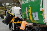 Rubbish truck with a worker emptying a bin.
