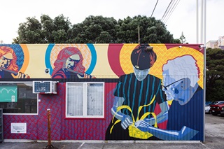 Painted picture of a young boy and his auntie on the side of a petrol station.