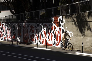 Person on a bike cycling up the road on a bike path.