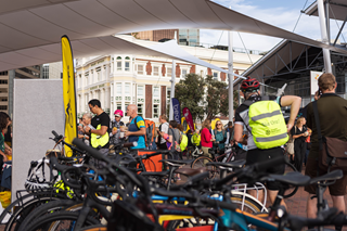 Image of a large crowd of people on and around bikes in front of TSB arena.