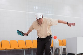 Elderly man playing pickleball at Ākau Tangi sports centre