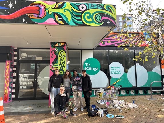 Xoë Hall and the rangatahi advisory group in front of the Te Tai Ohinga Mural