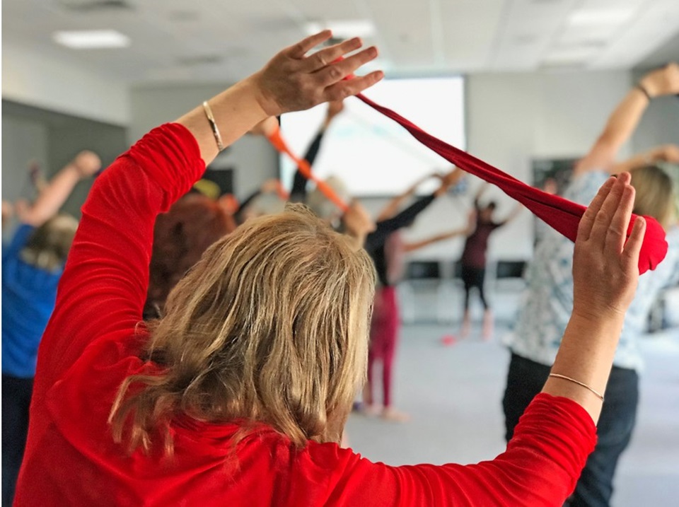 Woman doing stretching exercise during Seniors' Week at Karori Community Centre.