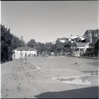Black and white archive photo of a an outdoor pool.