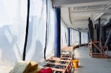 The inside of a building under construction with sheets on the side.