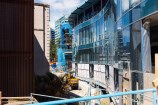 The exterior of a building under construction with wavy windows.